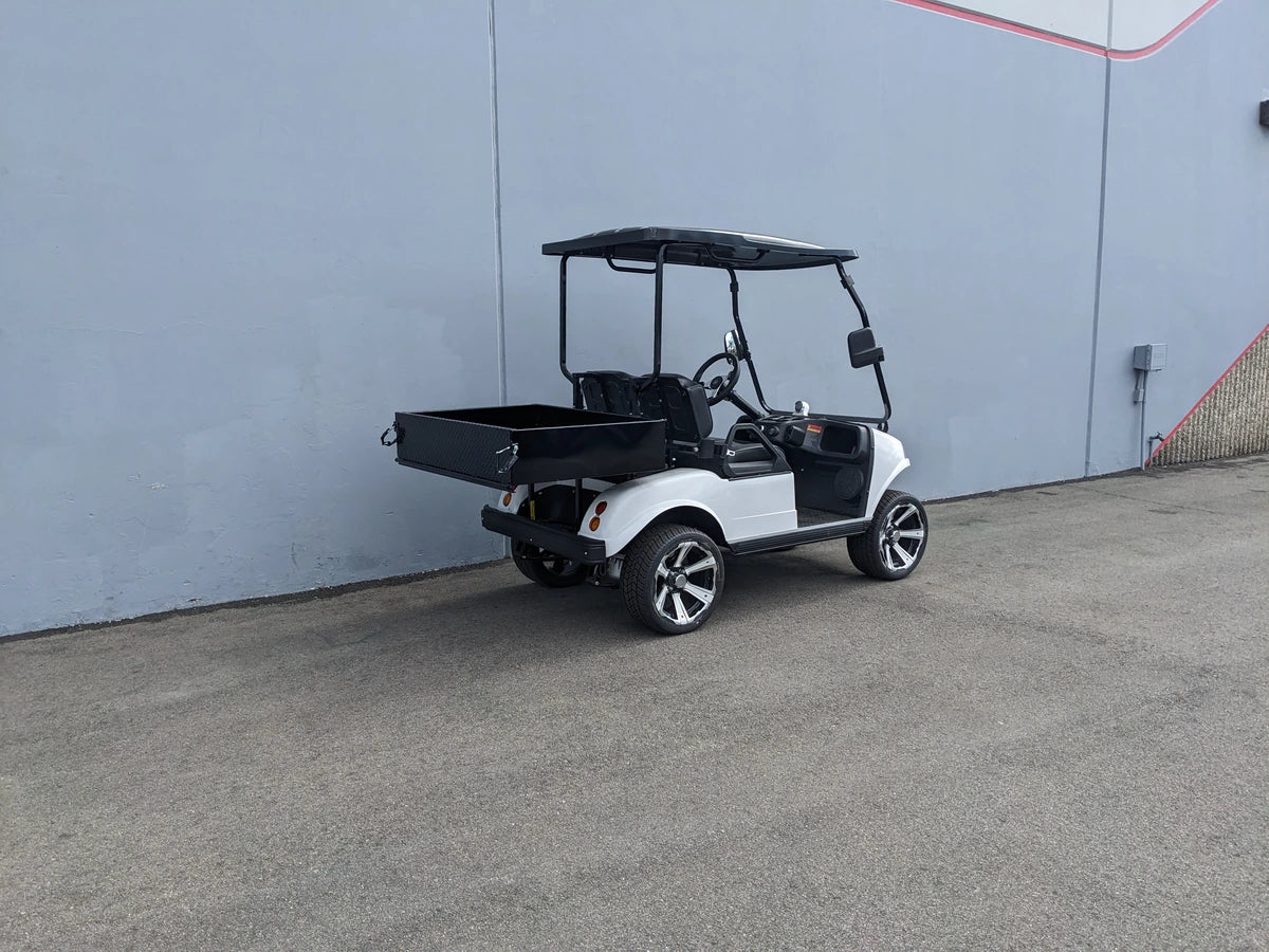 White golf cart equipped with an EVO-CLASSIC-UTIL31 EVOLUTION CLASSIC HEAVY-DUTY UTILITY BOX on the rear, showcasing custom fabrication for golf carts.