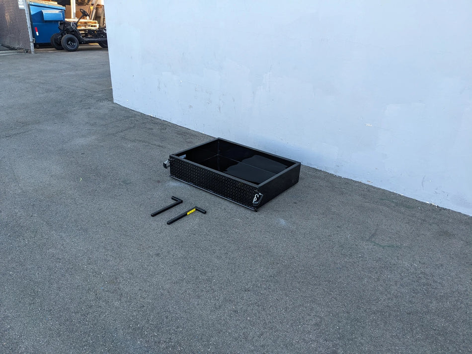 Black heavy-duty metal utility box with open compartments placed on pavement alongside tools, showcasing the EVO-CLASSIC-UTIL31 EVOLUTION CLASSIC HEAVY-DUTY UTILITY BOX designed for custom fabrication for golf carts.