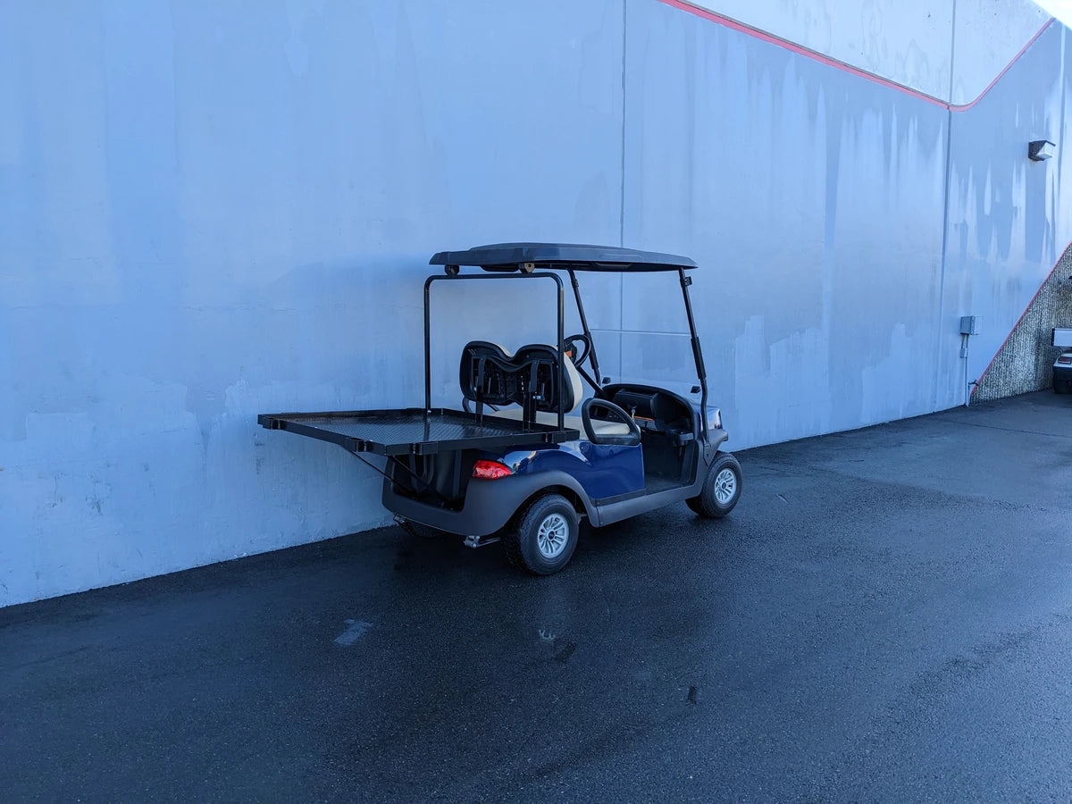 Golf cart equipped with CC-PREC-DECK48X48 SMALL FLATBED DECK custom fabricated for utility cargo and specialty golf cart beds in a parking lot.