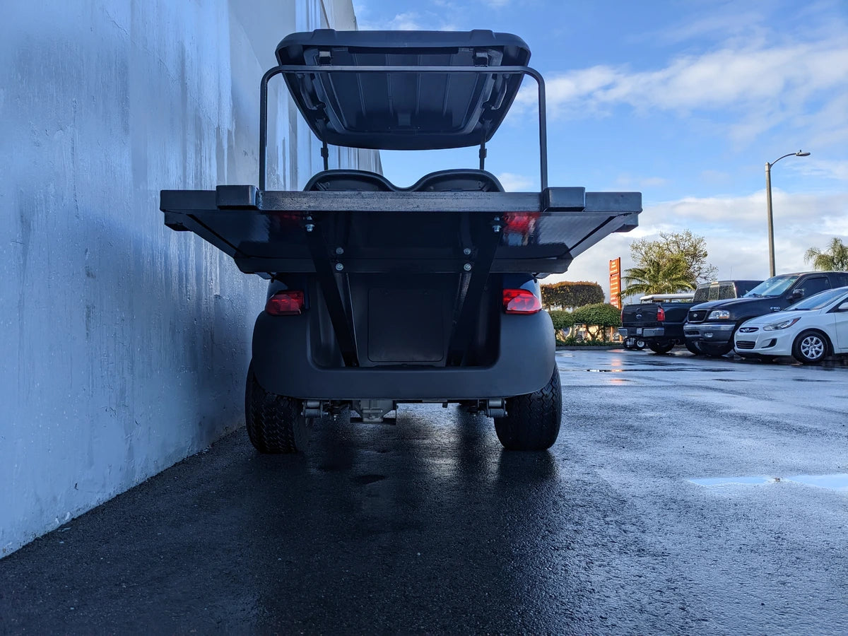 Rear view of a golf cart equipped with a CC-PREC-DECK48X48 SMALL FLATBED DECK, custom fabricated for golf carts, designed for hauling cargo and accessories.