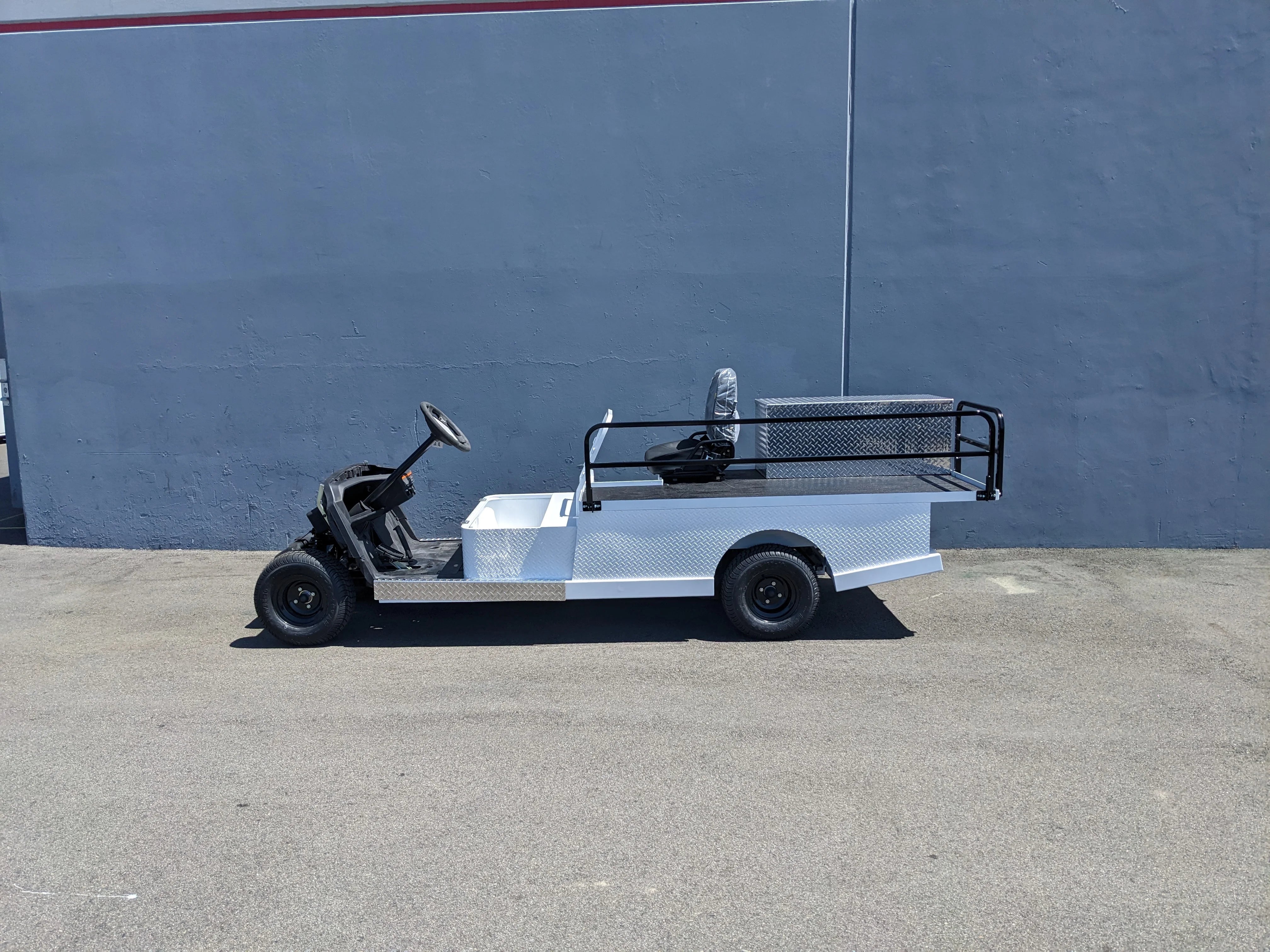 YAM-AMB-2SEAT-ST-FLAT-84 2Seat Ambulance Conversion on Yamaha Flatbed shown in white with custom fabrication for golf carts, featuring flatbed cargo area and utility railing.
