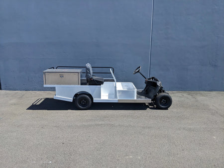 YAM-AMB-2SEAT-ST-FLAT-84 2Seat Ambulance Conversion on Yamaha Flatbed showing a custom fabrication for golf carts with a flatbed, storage box, and seating designed for utility and medical transport.