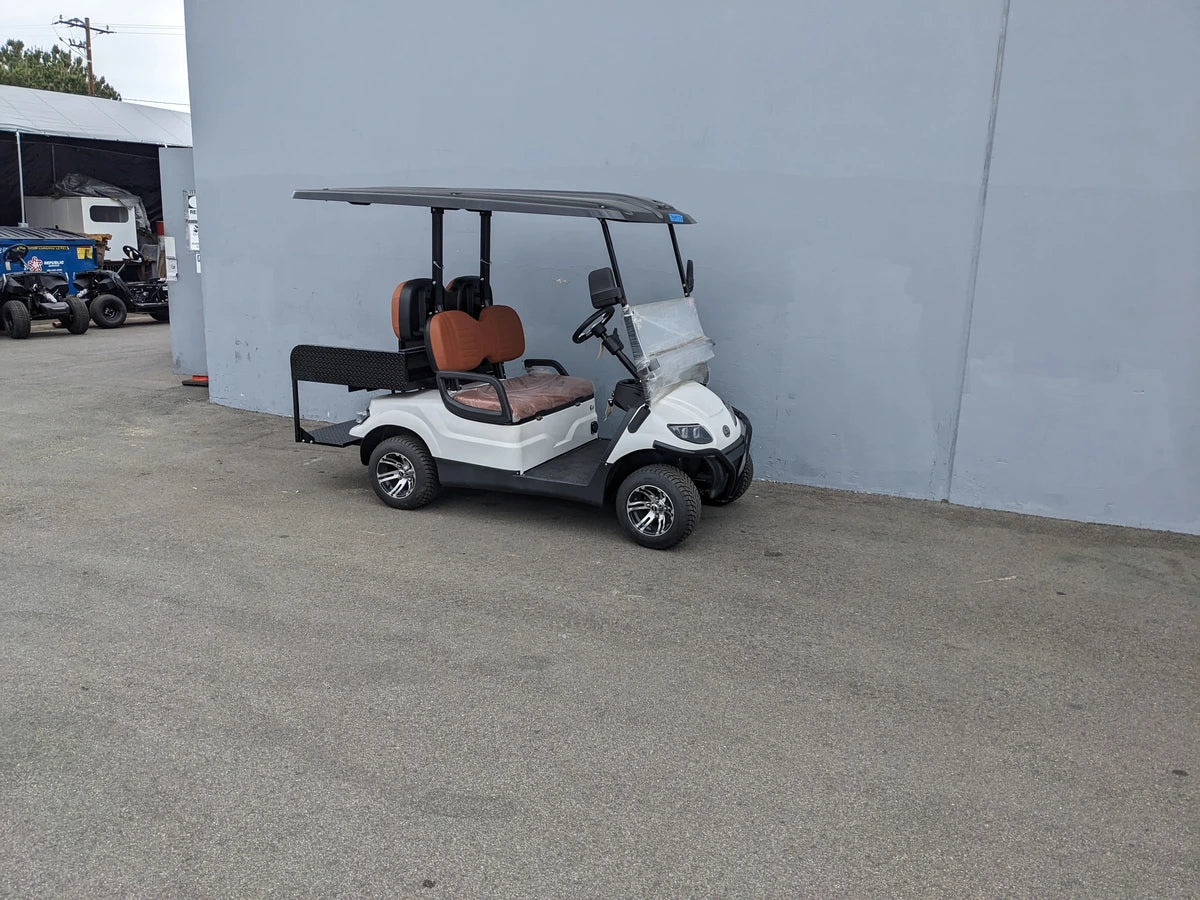 CRUISE-C40-BG CRUISE CAR/ICO C40 BRUSH GUARD installed on a white golf cart with brown seats, showcasing custom fabrication for golf carts and designed for enhanced protection and utility.