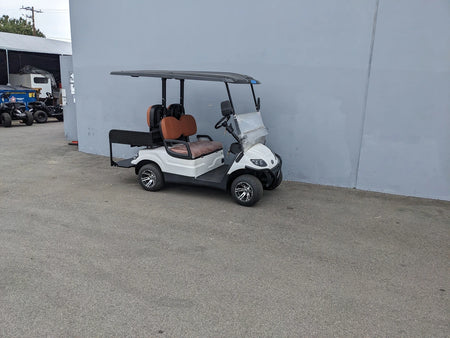 CRUISE-C40-BG CRUISE CAR/ICO C40 BRUSH GUARD installed on a white golf cart with brown seats, showcasing custom fabrication for golf carts and designed for enhanced protection and utility.