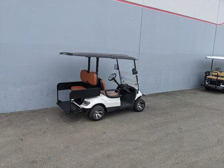 White golf cart equipped with CRUISE-C40-SB-COMBO CRUISE CAR/ICON C40 HEAVY-DUTY SEAT BACK COMBINATION SEAT/DECK KIT featuring orange seats and custom fabrication for golf carts.