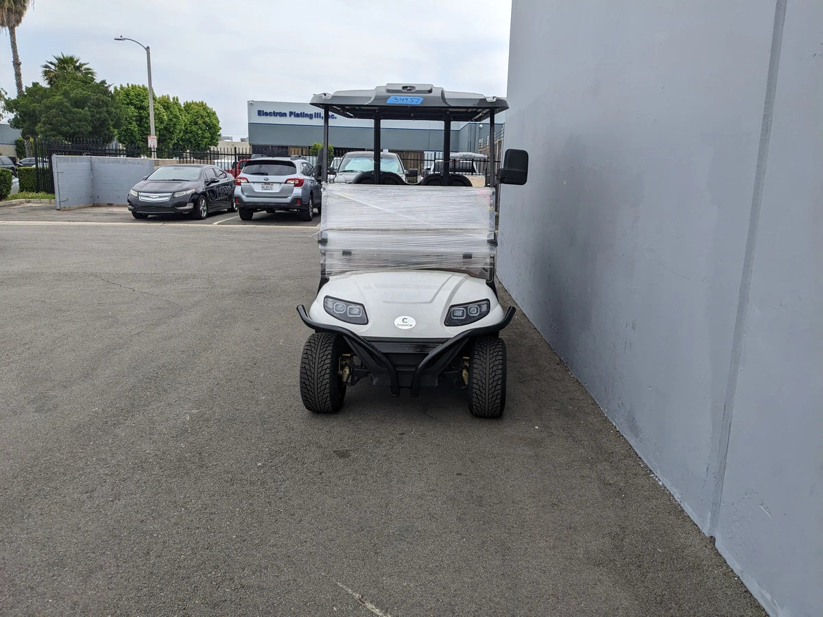 White golf cart front view equipped with CRUISE-C40-BG CRUISE CAR/ICO C40 BRUSH GUARD, featuring custom fabrication designed for golf carts.