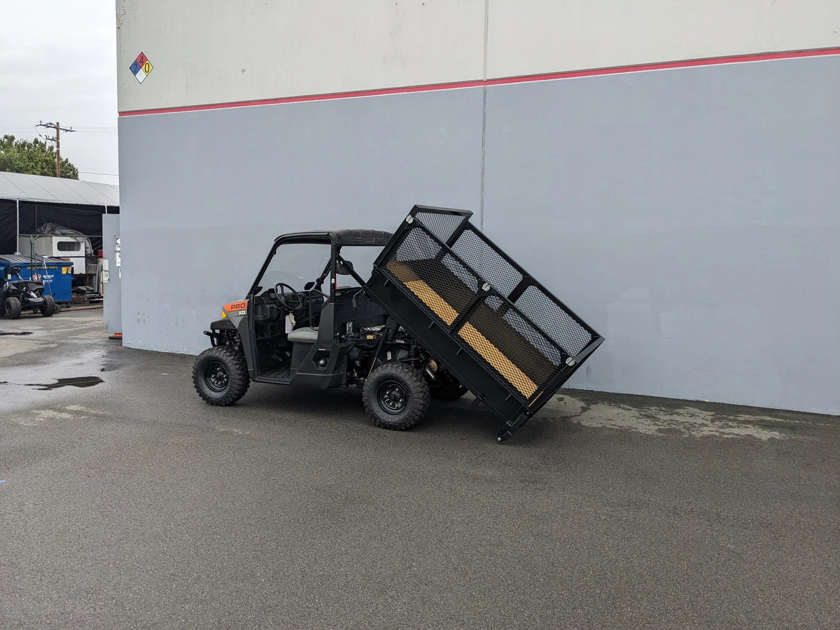 FB-POL-PROXD-54X76X11-DUMP TILT BED ACTUATOR WITH KEY FOB REMOTE installed on a utility vehicle showing custom fabrication for golf carts with a tilting cargo bed for easy dumping.