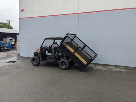 FB-POL-PROXD-54X76X11-DUMP TILT BED ACTUATOR WITH KEY FOB REMOTE installed on a utility vehicle showing custom fabrication for golf carts with a tilting cargo bed for easy dumping.