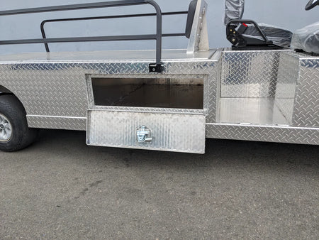 Close-up of the diamond plate metal storage compartment on the YAM-AMB-2SEAT-REAREMT-96X23 AMBULANCE CART, custom fabricated for golf carts with a hinged lockable door.