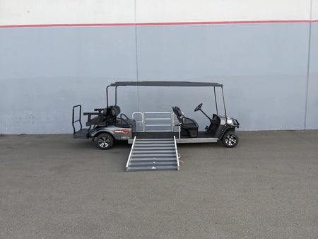 Golf cart modified with ramp and seating for wheelchair access, showcasing custom fabrication for golf carts and CUSH-WHEELCHAIR-TRANSPORT CUSHMAN GOLF CART CONVERSIONS FOR WHEELCHAIR PASSENGER.