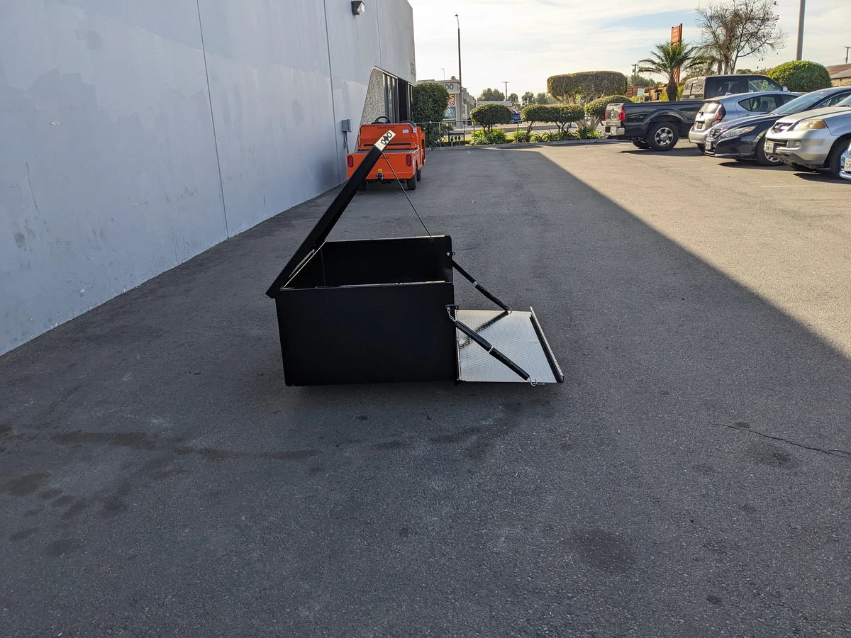 Black EZGO-TXT-CARGO31 EZ GO TXT LOCKING CARGO BOX with open lid and front door on pavement, designed for custom fabrication for golf carts and utility storage.