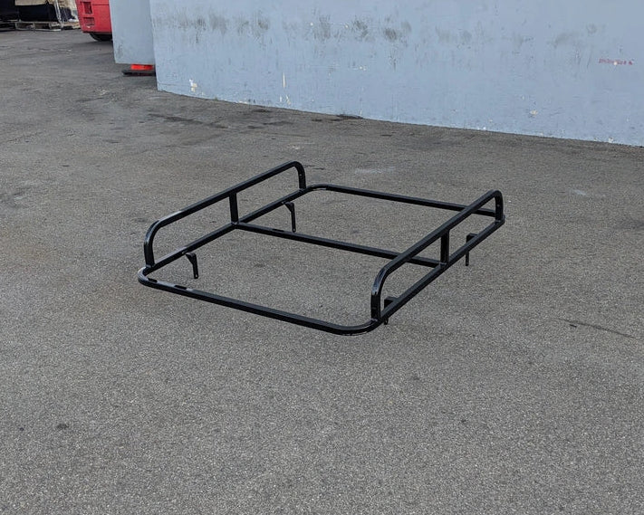 EVO-CLASSIC2-50LR EVOLUTION CLASSIC 2 LADDER RACK black metal frame resting on pavement, designed as a custom fabrication for golf carts to carry ladders and cargo.