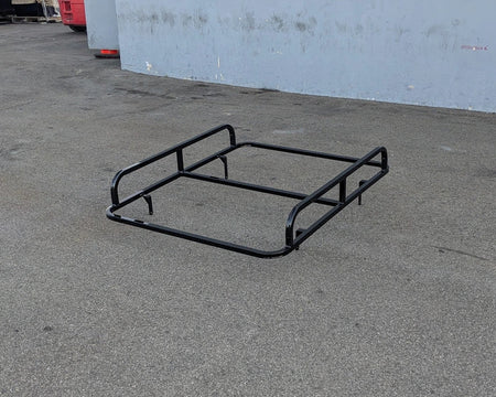 EVO-CLASSIC2-50LR EVOLUTION CLASSIC 2 LADDER RACK black metal frame resting on pavement, designed as a custom fabrication for golf carts to carry ladders and cargo.