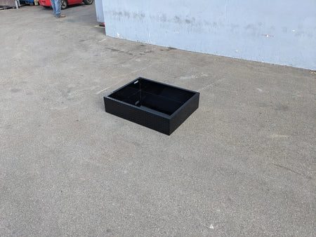 Black utility storage box on pavement featuring the ICON-I40-RUB31-40WIDE Removable Utility Box Insert for Icon I40 Flip-Seat, custom fabricated for golf carts.