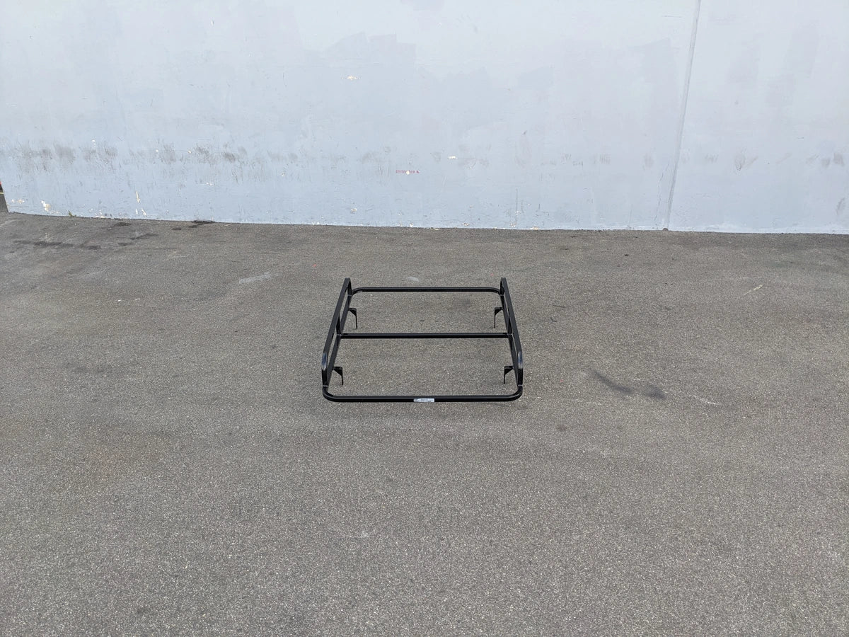 EZGO-TXT14+VLRCHP-54LR EZ GO TXT 2014 AND NEWER, VALOR, CUSHMAN HAULER PRO HEAVY-DUTY LADDER RACK flat black custom fabrication for golf carts shown on pavement against gray wall background.