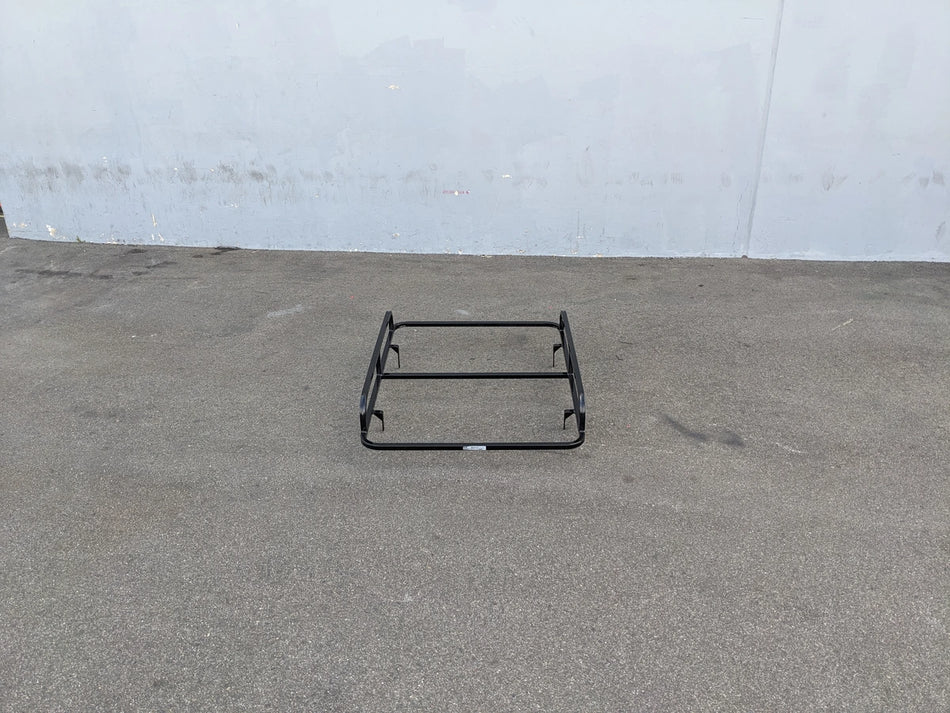 EZGO-TXT14+VLRCHP-54LR EZ GO TXT 2014 AND NEWER, VALOR, CUSHMAN HAULER PRO HEAVY-DUTY LADDER RACK flat black custom fabrication for golf carts shown on pavement against gray wall background.