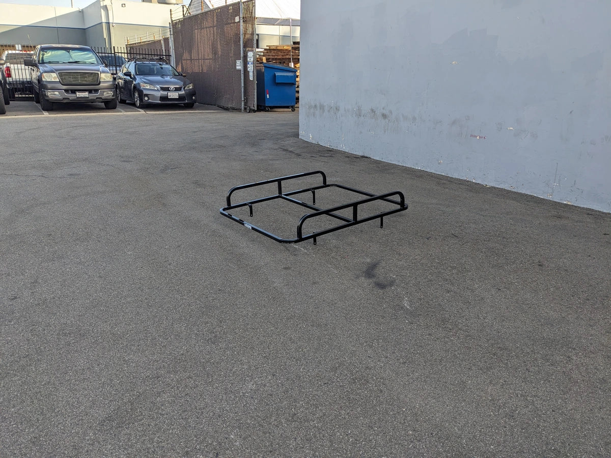 EZGO-TXT14+VLRCHP-54LR EZ GO TXT 2014 AND NEWER, VALOR, CUSHMAN HAULER PRO HEAVY-DUTY LADDER RACK black metal cart hauler rack designed for custom fabrication on golf carts, shown on asphalt surface outdoors.