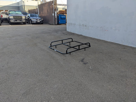 EZGO-TXT14+VLRCHP-54LR EZ GO TXT 2014 AND NEWER, VALOR, CUSHMAN HAULER PRO HEAVY-DUTY LADDER RACK black metal cart hauler rack designed for custom fabrication on golf carts, shown on asphalt surface outdoors.