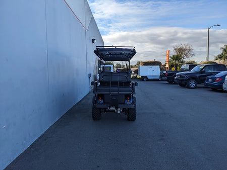 Rear view of a golf cart equipped with the EVO-CLASSIC2-6PASS-84RR3 EVOLUTION CLASSIC 6 PASSENGER ROOF RACK, showcasing custom fabrication designed for golf carts.