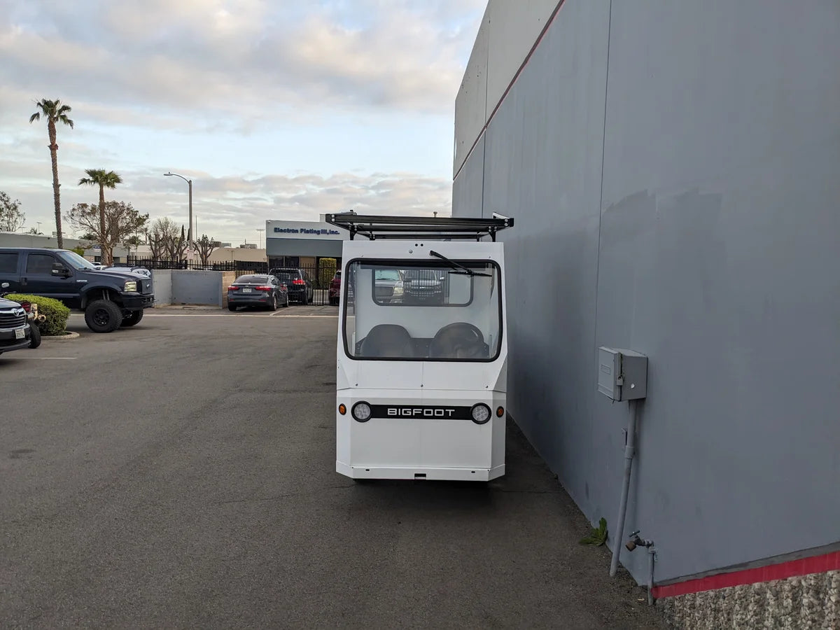TD-BIG-44X120-TLRI Top Mount Ladder Rack for mounting inside the bed of a Taylor Dunn Bigfoot golf cart, custom fabrication for golf carts shown in an outdoor industrial setting.