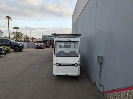 TD-BIG-44X120-TLRI Top Mount Ladder Rack for mounting inside the bed of a Taylor Dunn Bigfoot golf cart, custom fabrication for golf carts shown in an outdoor industrial setting.
