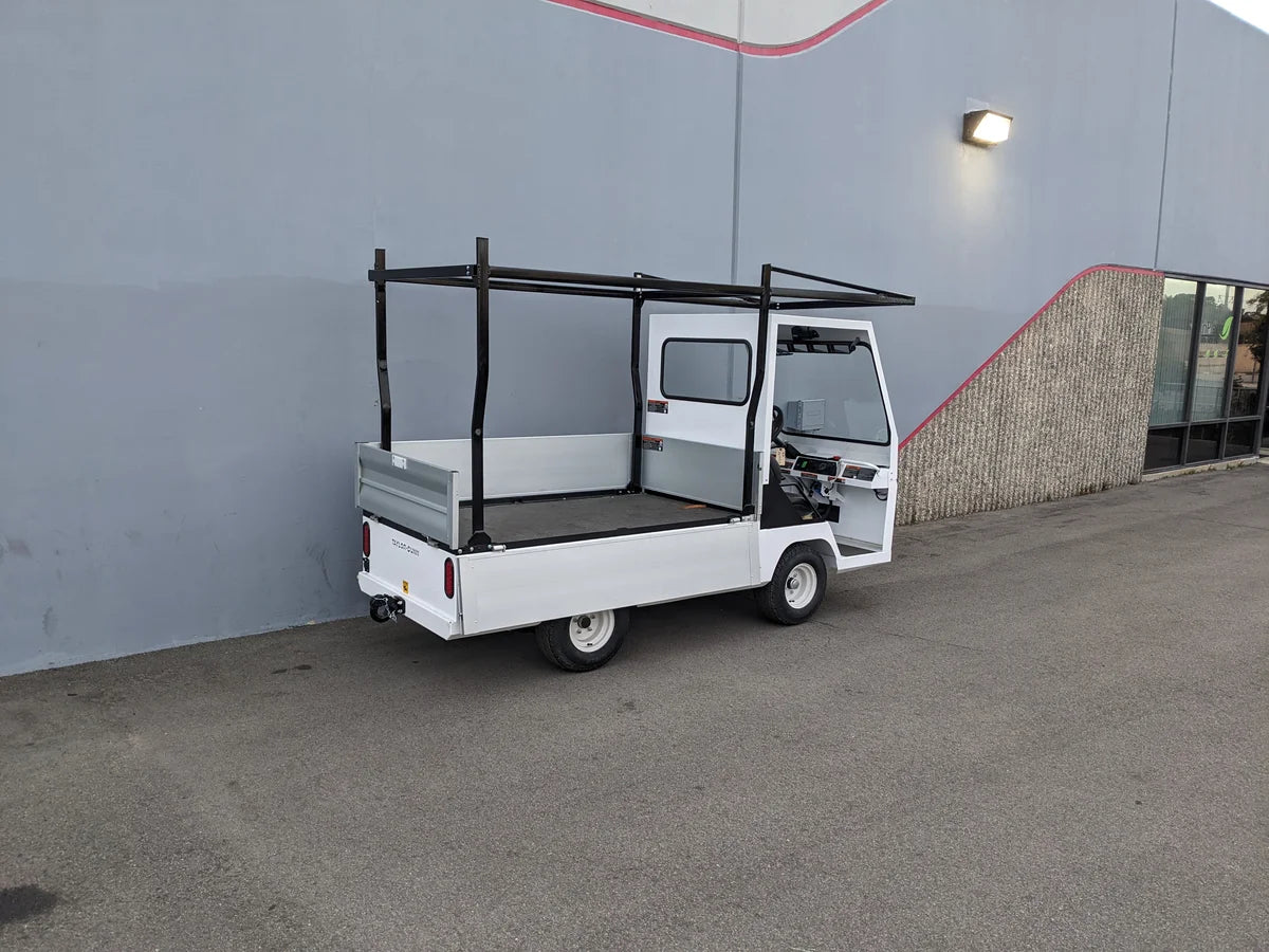 White utility golf cart with an installed TD-BIG-44X120-TLRI Top Mount Ladder Rack for mounting inside the bed of a Taylor Dunn Bigfoot, showcasing custom fabrication for golf carts.