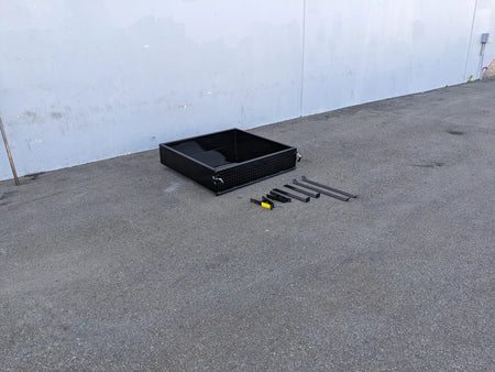 Black CC-PREC-UTIL42 CLUB CAR PRECEDENT EXTENDED UTILITY BOX WITH TAILGATE and custom fabrication parts for golf carts displayed on concrete floor near white wall.