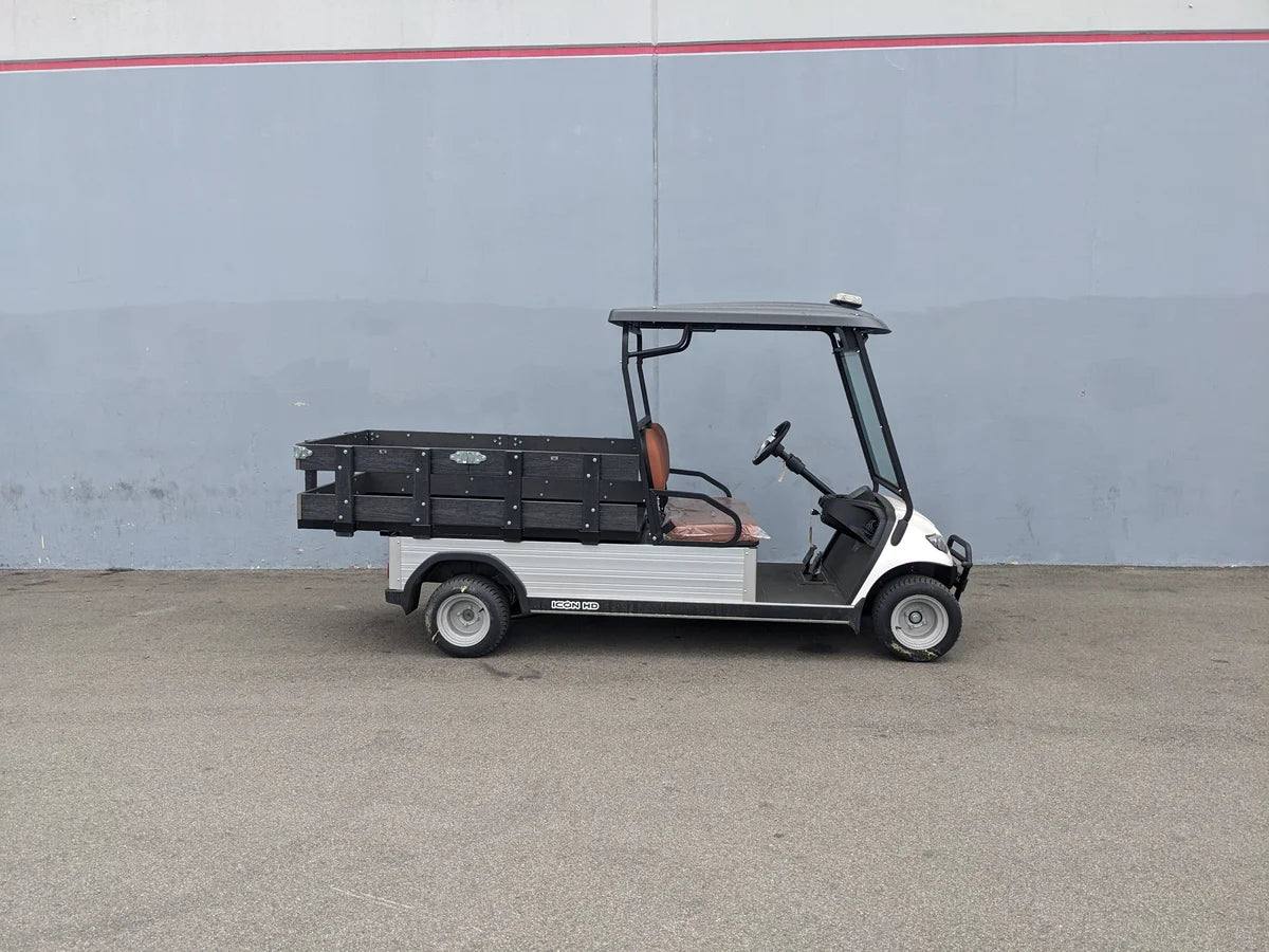 Golf cart featuring custom flatbed with STAKE-SIDES-44X72X18-COMP Flatbed Golf Cart Composite Stake Sides, designed for cargo and utility use with composite materials.
