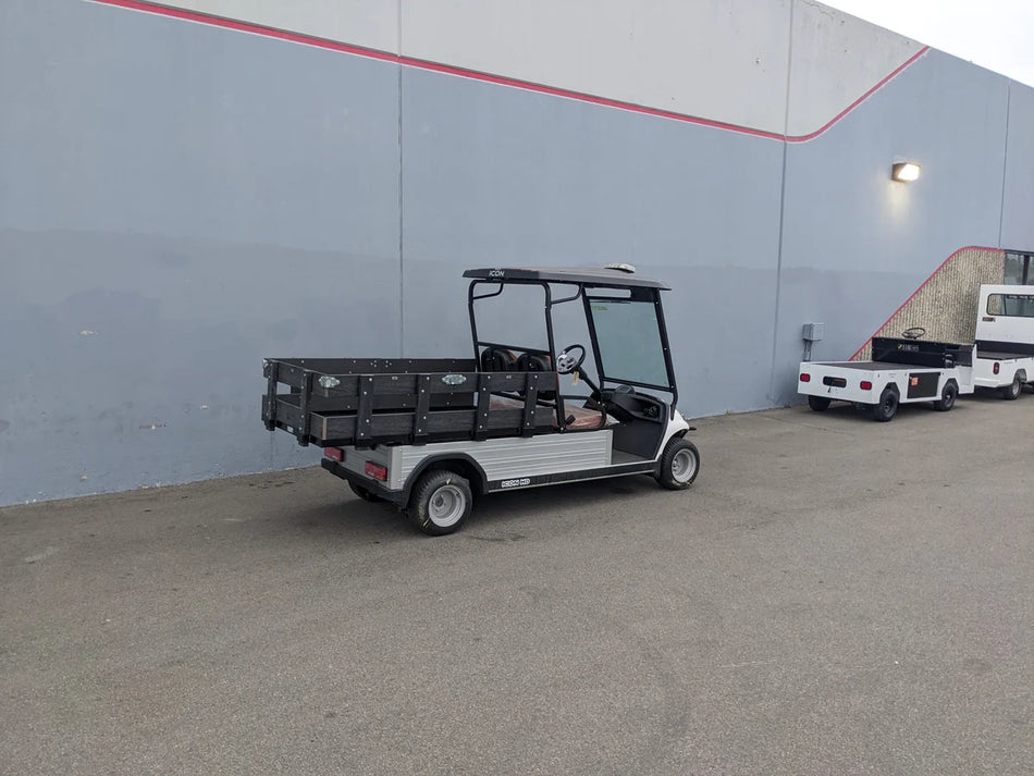 Golf cart equipped with STAKE-SIDES-44X72X18-COMP Flatbed Golf Cart Composite Stake Sides for custom fabrication, designed for cargo and utility hauling applications.