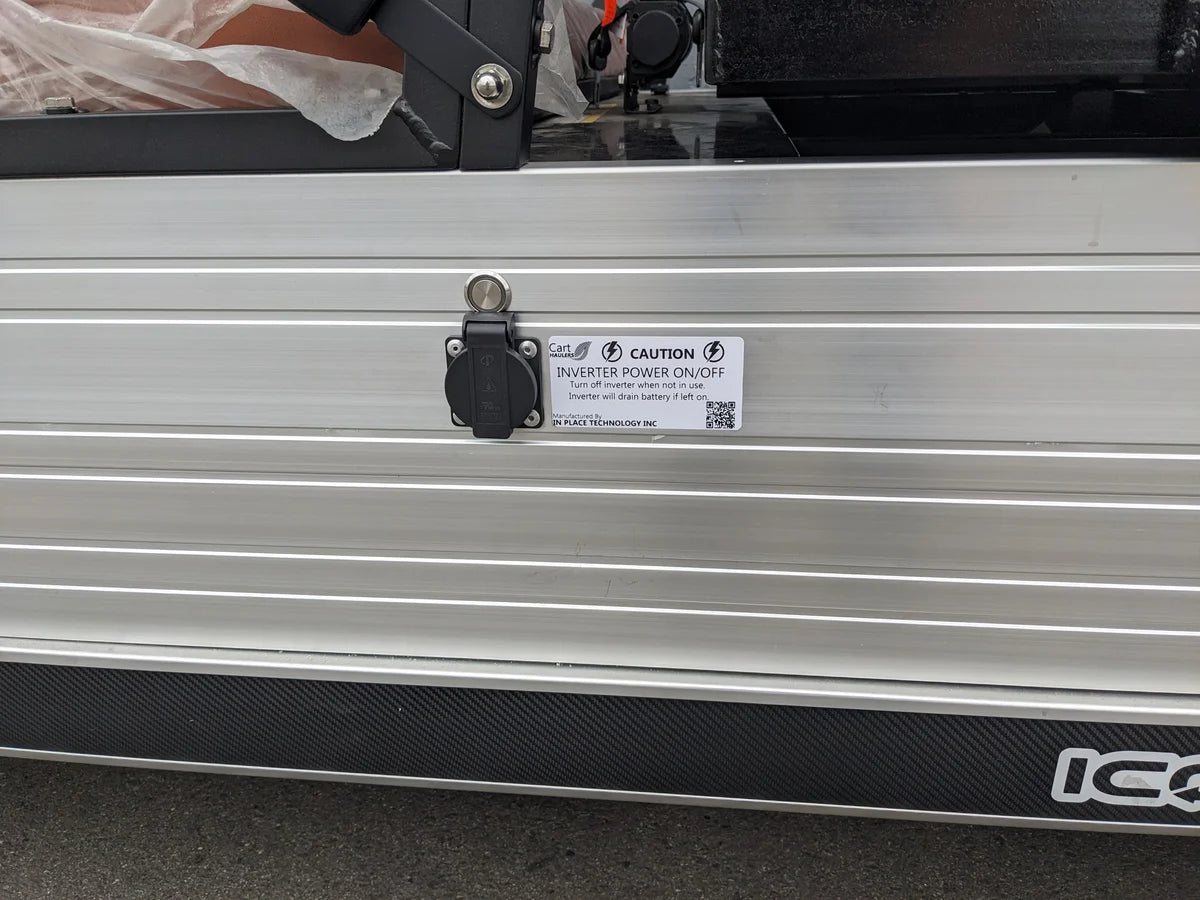 Close-up view of a metal panel featuring a power outlet with a switch labeled for inverter power on/off, part of the INVERTER-ICONC20U2013+-5000W Inverter Installation to Supply 15Amp 120VAC Outlet with Switch, custom fabricated for golf carts.
