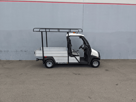 White utility golf cart equipped with a black steel ladder rack and cab guard, featuring the CC-710-50X96-CHASSIS-TLRA-GUARD CLUB CAR 710 TOP LADDER RACK AND CAB GUARD for cargo and utility transport.