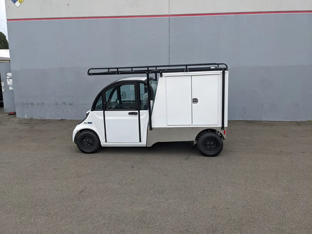 White utility golf cart equipped with a GEM-ELXD-53X120-TLR Top Mount Ladder Rack for outside mount on a GEM ELXD, featuring custom fabrication for golf carts and storage compartments.