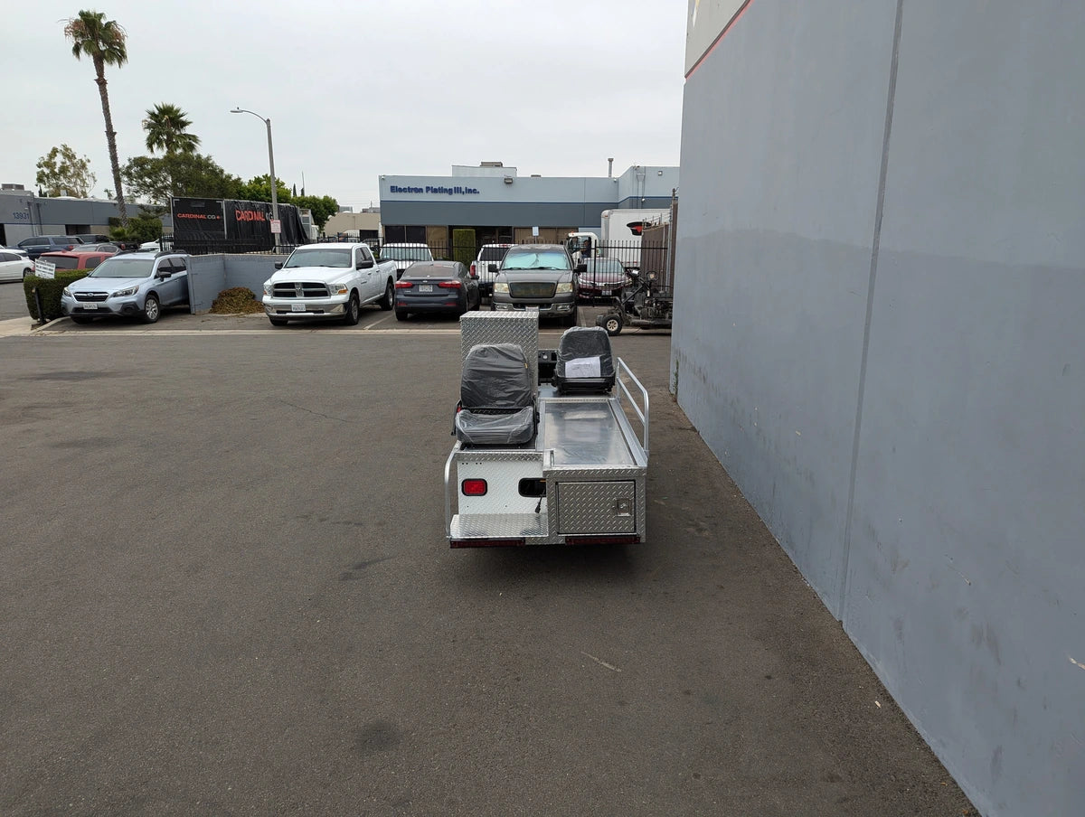 Rear view of a custom-fabricated CUSH-TITAN-3SEAT-84X23 Ambulance Conversion for Cushman Titan golf cart, featuring specialty seating, utility boxes, and cargo space for medical transport.