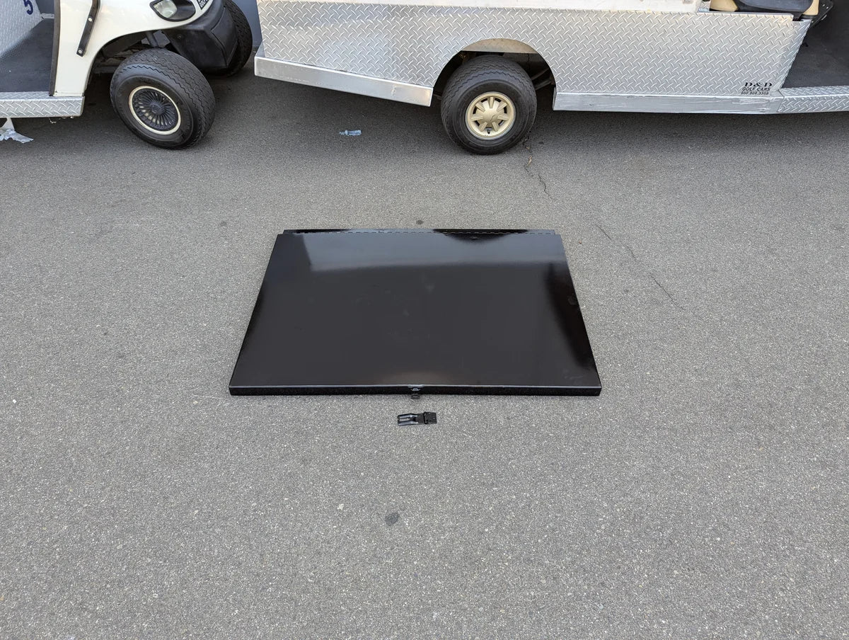 UTIL31-LID RETROFIT LOCKING LID FOR CART HAULERS UTILITY BOXES shown as a sleek black locking lid designed for custom fabrication on golf carts, placed on pavement near a golf cart.