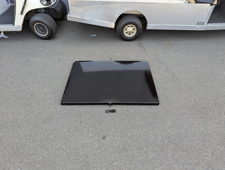 UTIL31-LID RETROFIT LOCKING LID FOR CART HAULERS UTILITY BOXES shown as a sleek black locking lid designed for custom fabrication on golf carts, placed on pavement near a golf cart.