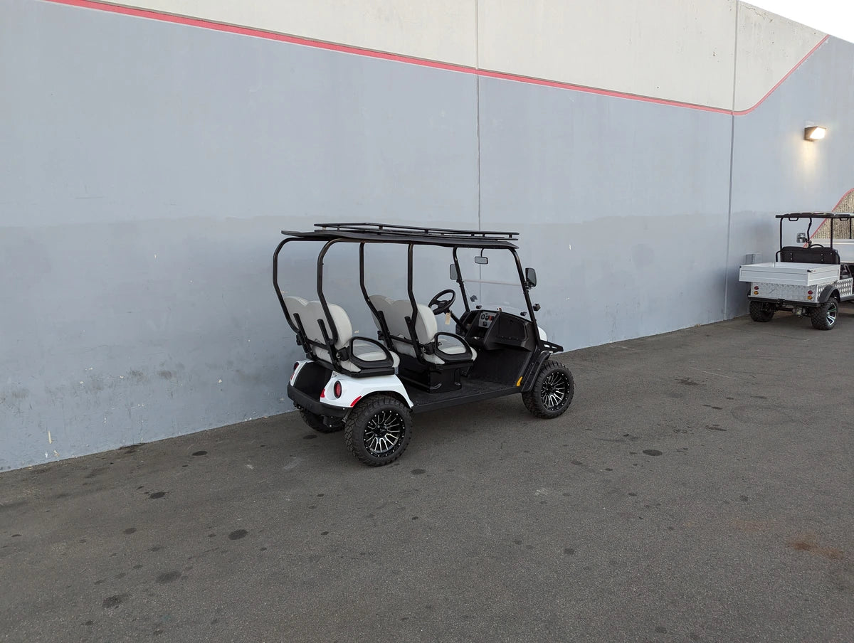 EZGO-LIBERTY-64RR3 EZ GO LIBERTY ROOF RACK installed on a white golf cart parked outdoors, showcasing custom fabrication designed for golf carts with cargo and utility carrying capability.