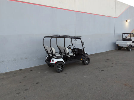 EZGO-LIBERTY-64RR3 EZ GO LIBERTY ROOF RACK installed on a white golf cart parked outdoors, showcasing custom fabrication designed for golf carts with cargo and utility carrying capability.