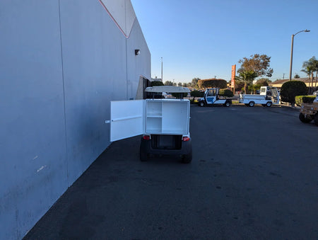 TB-36X18X28-FH BED MOUNT TOOLBOX WITH HINGED DOOR installed on a golf cart, shown open to reveal interior compartments, custom fabrication for golf carts.