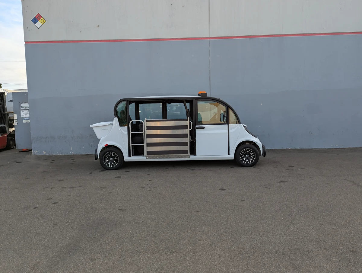 Side view of a white custom golf cart with side entry door and lowered floor designed for wheelchair access, showcasing the GEM-E6 WHEELCHAIR TRANSPORT GEM GOLF CART CONVERSION FOR WHEELCHAIR PASSENGER with custom fabrication for golf carts.
