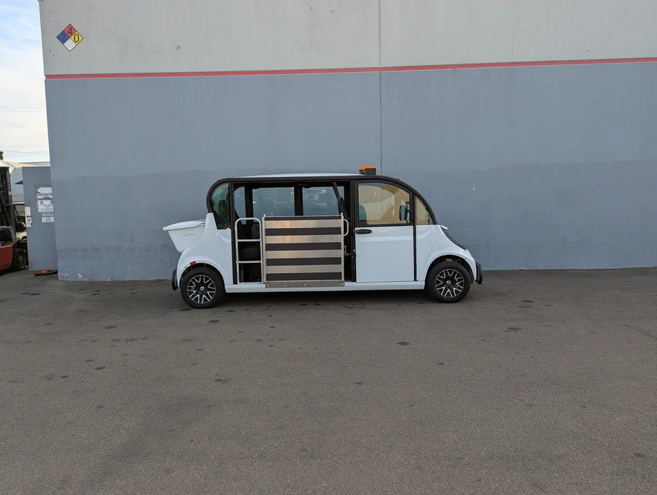 Side view of a white custom golf cart with side entry door and lowered floor designed for wheelchair access, showcasing the GEM-E6 WHEELCHAIR TRANSPORT GEM GOLF CART CONVERSION FOR WHEELCHAIR PASSENGER with custom fabrication for golf carts.