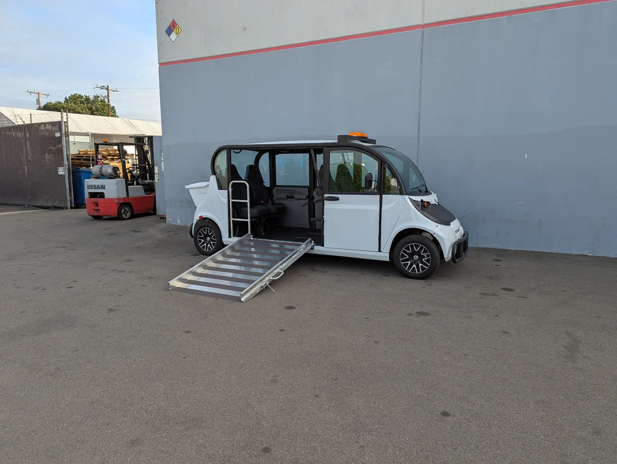 White electric golf cart modified with an extended ramp and open side door for wheelchair access, featuring the GEM-E6 WHEELCHAIR TRANSPORT GEM GOLF CART CONVERSION FOR WHEELCHAIR PASSENGER and custom fabrication for golf carts.
