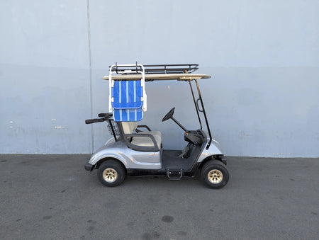 Side view of a silver golf cart equipped with a CH-9MOUNT CHAIR HOOK FOR GOLF CART RACKS holding a folded chair, custom fabrication designed for golf carts and accessory racks.