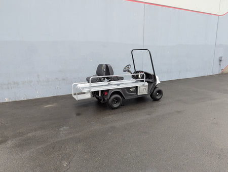 CUSH-EMT-84X24 EMT GOLF CART BED CONVERSION FOR CUSHMAN GOLF CART shown as a custom fabrication flatbed with metal railings on a Cushman golf cart for cargo and utility use.