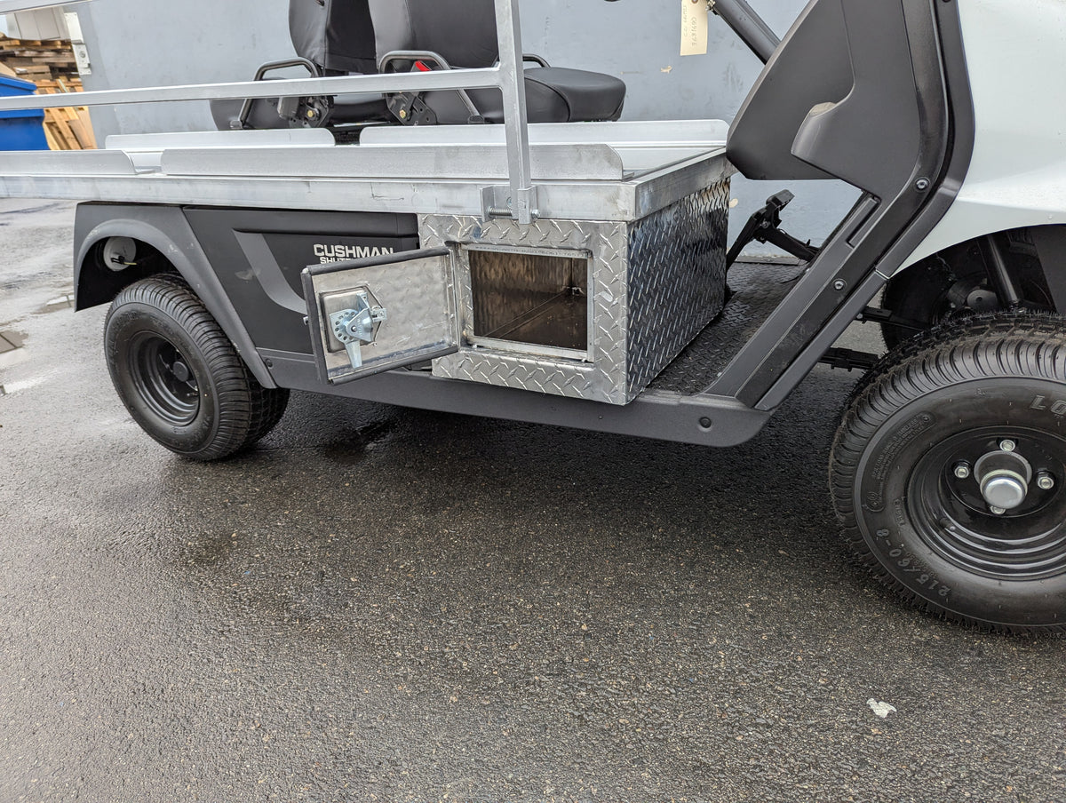 CUSH-EMT-84X24 EMT GOLF CART BED CONVERSION FOR CUSHMAN GOLF CART showing custom fabrication with diamond plate storage box and open compartment on golf cart utility bed.