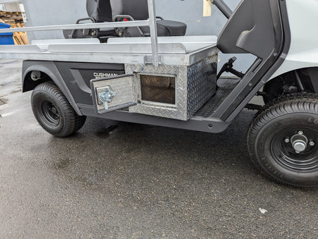 CUSH-EMT-84X24 EMT GOLF CART BED CONVERSION FOR CUSHMAN GOLF CART showing custom fabrication with diamond plate storage box and open compartment on golf cart utility bed.