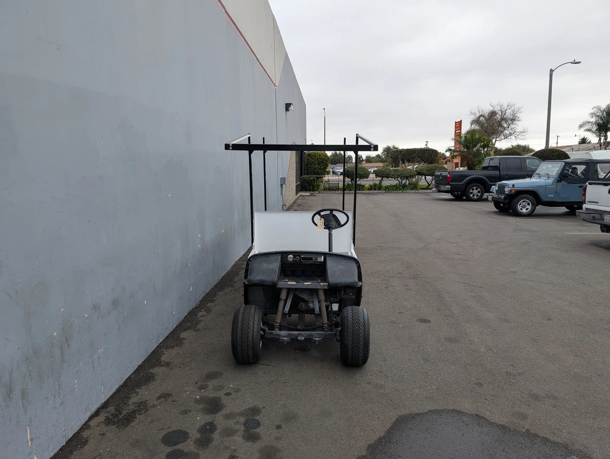 Golf cart equipped with FB-45X120-TLR FLATBED TOP LADDER RACK, 45″ X 120″ WITH REMOVABLE REAR CROSS BAR designed for custom fabrication and utility cargo transport.