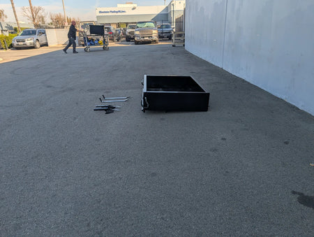 CC-PREC-UTIL31 CLUB CAR PRECEDENT HEAVY-DUTY INDUSTRIAL UTILITY BOX WITH TAILGATE resting on pavement outdoors, alongside mounting hardware, custom fabrication for golf carts.