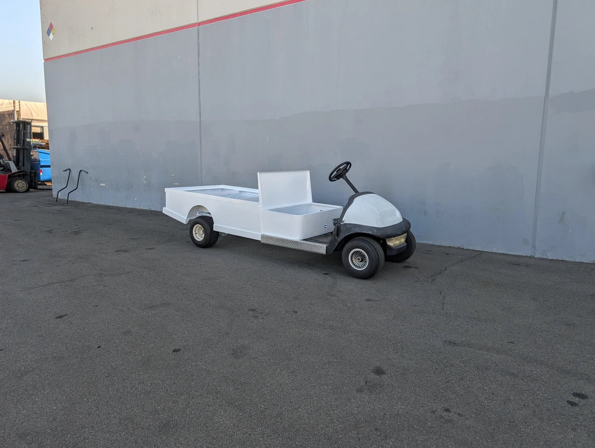 CC-PREC-ST-FLAT-72 CLUB CAR PRECEDENT 6 FOOT FLATBED CONVERSION showing custom fabrication for golf carts with a white flatbed utility surface attached to a golf cart base.