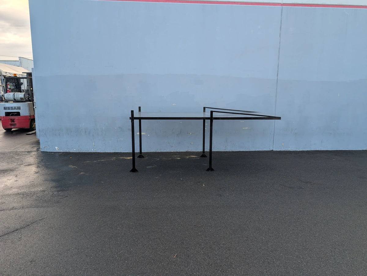 FB-45X120-TLR DECK 10 FT Top Mount Ladder Rack for Flatbed with Solid Deck black metal frame standing on asphalt, custom fabrication for golf carts.