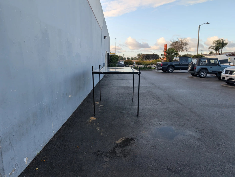 FB-45X120-TLR DECK 10 FT Top Mount Ladder Rack for Flatbed with Solid Deck displayed outdoors near a building wall, showcasing sturdy metal construction for custom fabrication for golf carts.